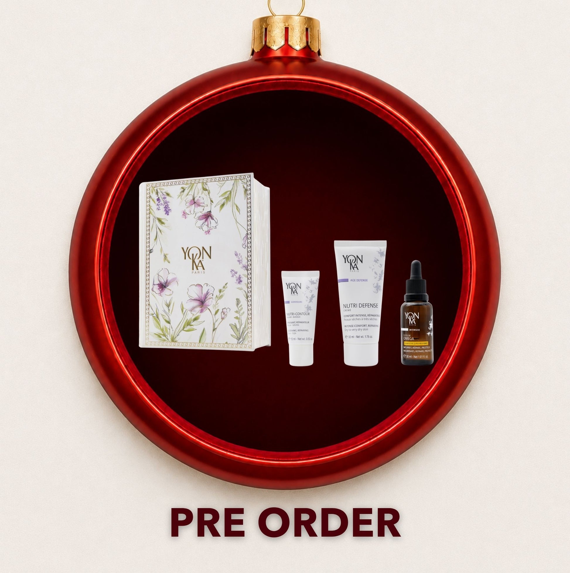 Yon-Ka Nutrition and Repair gift set displayed inside a red Christmas bauble
